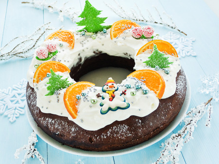 Chocolate Christmas cake with candies, tangerine and whipped cream. Shallow dof.の写真素材