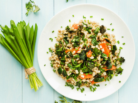 Boiled pearl barley with nettle, carrot and leek. Shallow dof.の写真素材