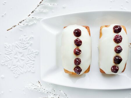 Christmas fruitcakes with whipped cream and cherry. Shallow dof.の写真素材