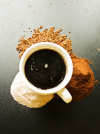 Cup of coffee on the black table. Shallow dof.の写真素材