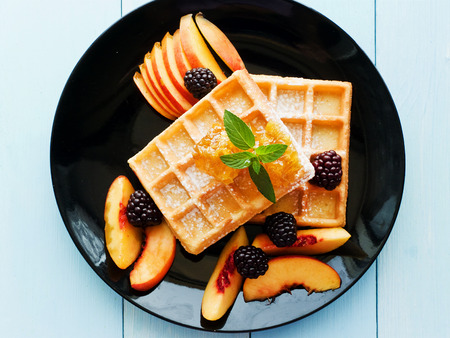 Belgium waffles with fruits, berries and honey. Shallow dof.の写真素材