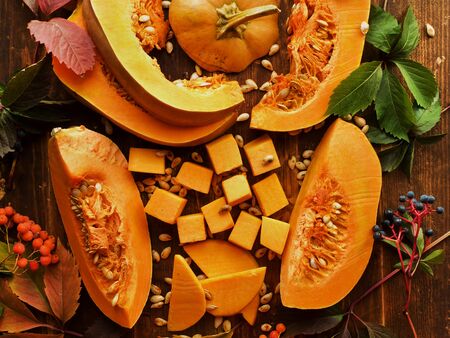 Sliced pumpkin on the wooden background. Viewed from above.の写真素材