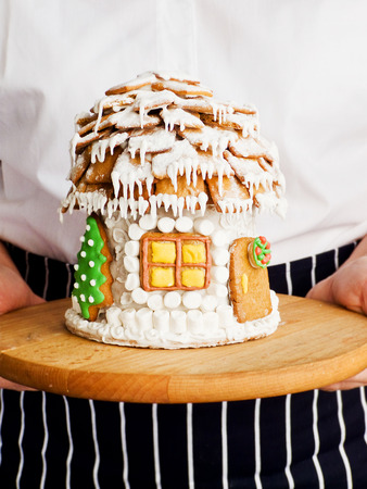 Christmas gingerbread house on wood. Shallow dof.の写真素材