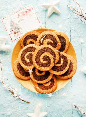 Chocolate orange pinwheel cookies on blue. Shallow dof.の写真素材