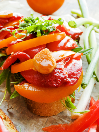 Toasts with stir-fry wax pepper and tomatoes. Shallow dof.の写真素材