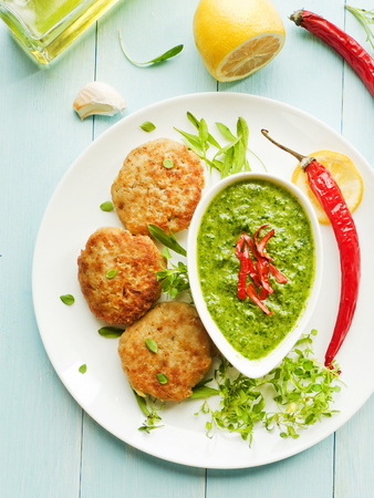 Fish cutlets and green sauce. Shallow dof.の写真素材