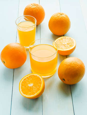 Orange juice in glass with sliced fruits