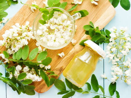 Acacia syrup homemade honey with flowers on wood. Shallow dof.