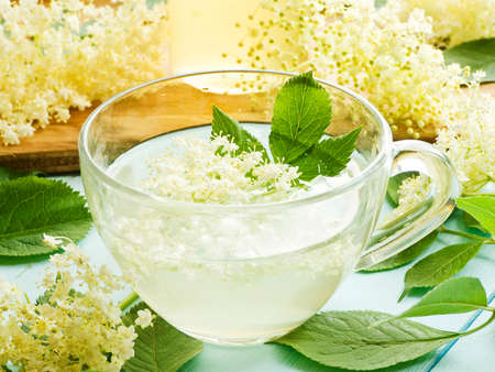 Elderberry syrup homemade honey with flowers on wood. Shallow dof.の写真素材