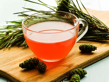 Pine cone tree homemade jam tea on wooden background. Shallow dof.