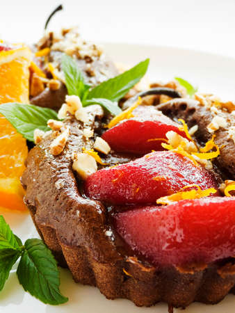 Christmas dessert mulled pear mini cakes with oranges and nuts. Shallow dof.の写真素材