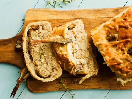 Homemade fish pie on wooden background. Shallow dof.