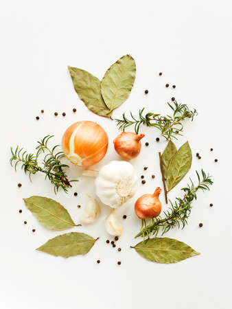 Herbs, spices and vegetables on the white wooden background. Shallow dof.の写真素材