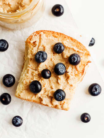 White bread toast with peanut butter and blueberries. Shallow dof.