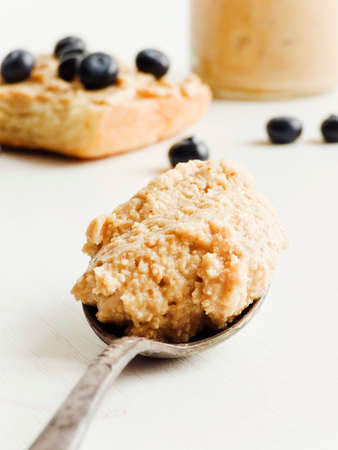 Spoon with peanut butter closeup shot. Shallow dof.