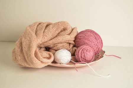 pink and white woolen balls with woolen scarf