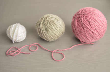 pastel woolen balls on gray wooden groundの写真素材