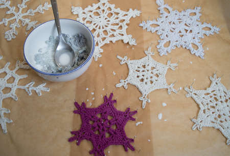 handmade crochet white snowflakes stiffen with needlesの写真素材
