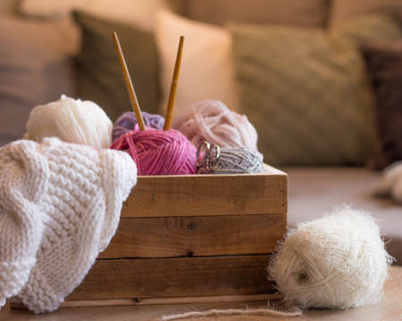 Colorful woolen balls in a wooden box with bamboo knitting needles handmadeの写真素材