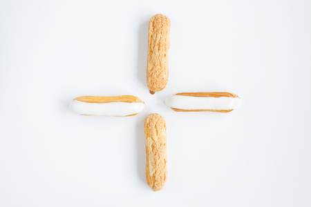 delicious , delicate Eclair with custard cream and vanilla cream on the white background . close-upの写真素材