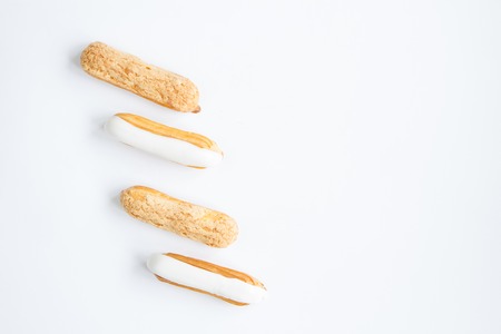 delicious , delicate Eclair with custard cream and vanilla cream on the white background . close-upの写真素材
