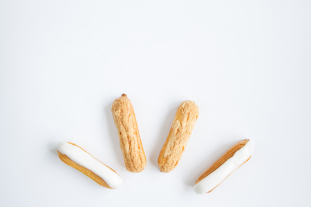 delicious , delicate Eclair with custard cream and vanilla cream on the white background . close-upの写真素材