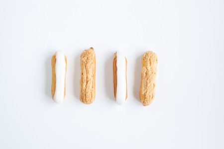 delicious , delicate Eclair with custard cream and vanilla cream on the white background . close-upの写真素材