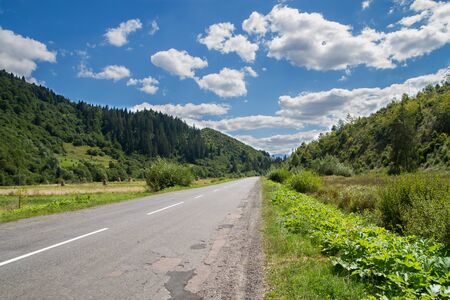 beautiful view of the road in the mountains , blue sky with clouds. summerの写真素材