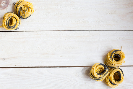 homemade pasta on the wooden background. Free space for textの写真素材