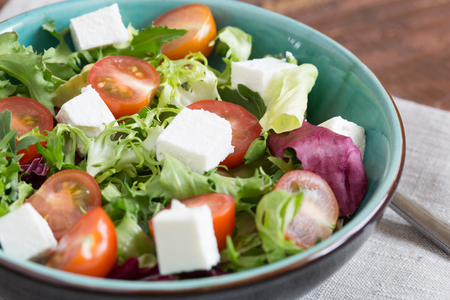 Salad with cherry tomatoes, Radicchio lettuce, frize, arugula and fetaの写真素材