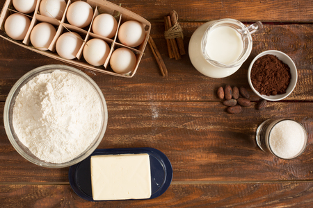 Ingredients for making cinnamon rolls on a wooden backgroundの写真素材