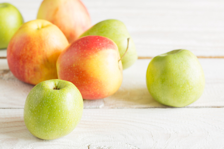 Ripe apples on a wooden tableの写真素材