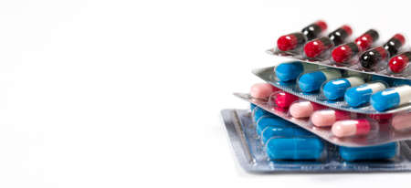 Different colorful pills on white background. Medical concept.