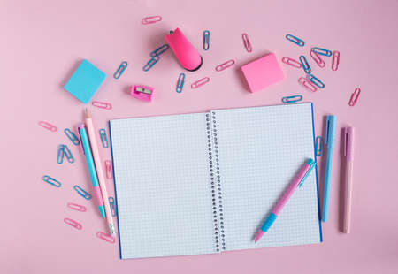 School notebook and stationery on a pink background. Back to school conceptの写真素材