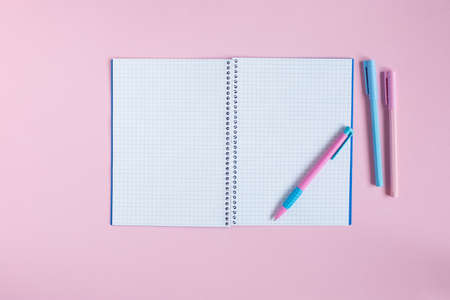 School notebook and stationery on a pink background.の写真素材