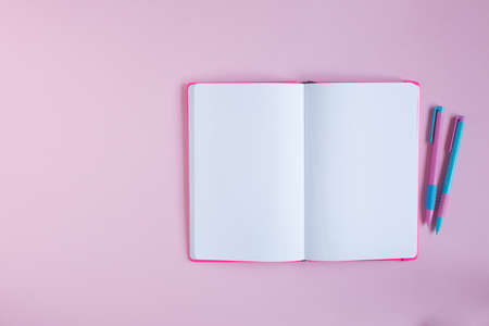 notebook and stationery on a pink background.の写真素材