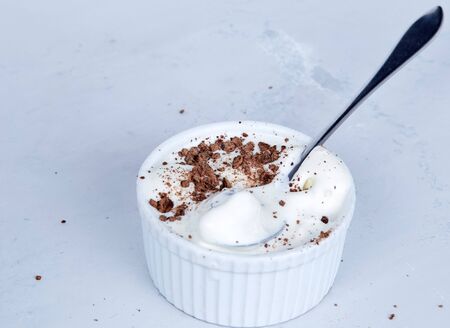 Homemade vanilla ice cream with chocolate chips in a bowl with a spoon.の写真素材