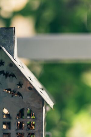 Vintage old-fashioned retro Halloween outdoor decorations. Garden Halloween decor with pumpkin, metal house.の写真素材