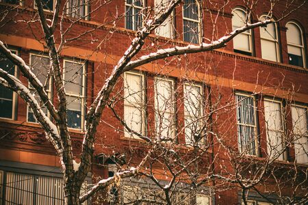 Snow and sunny day in Denver city. Downtown streets with snow. Financial district on a snow day.の写真素材