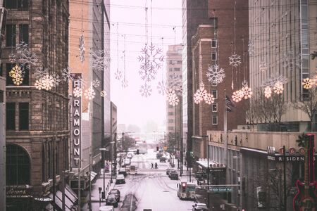 New Year's Eve snowing day in the city. Showing in the streets of Downtown. Snowy city streetsの写真素材