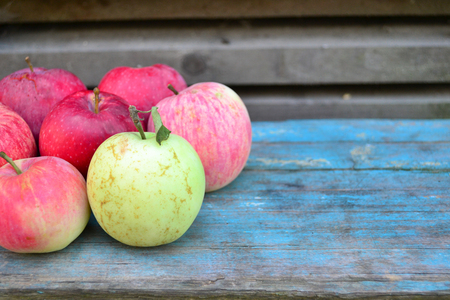 Natural ripe red apples on a blue backgroundの写真素材