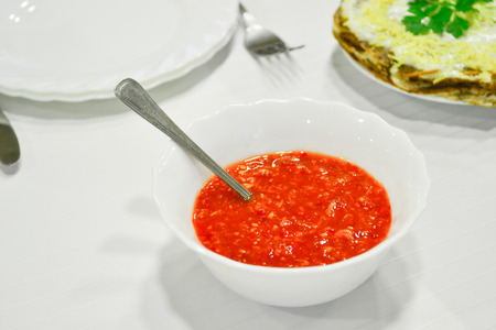 Red sauce in the plate on the tableの写真素材