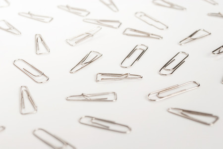 many paper clips on a white backgroundの写真素材