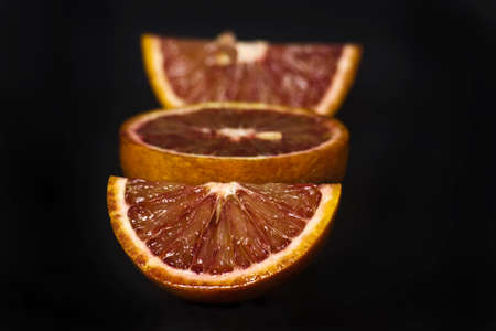 orange slice shot in the studio isolated on blackの写真素材