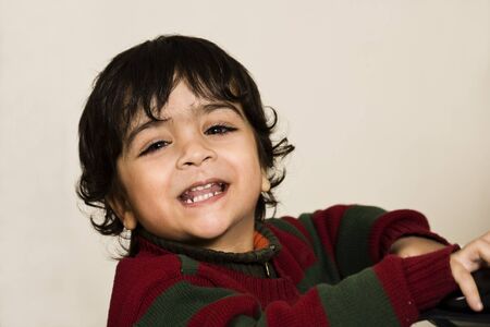 happy cute little boy laughing over something.の写真素材