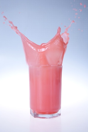 strawberry milk shake splashing put of a glass on isolated back ground の写真素材