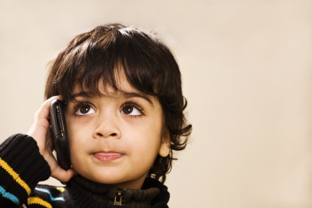 little boy talking to his daddy over the phone の写真素材