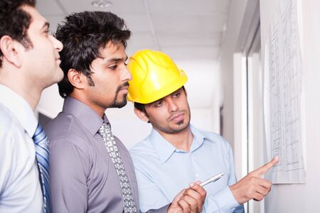 businessmen in meeting with architectの写真素材