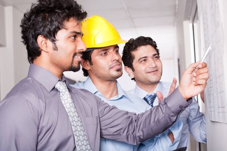 businessmen in meeting with architectの写真素材