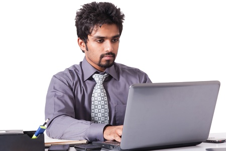 confident Indian businessman working on the laptop isolated on whiteの写真素材